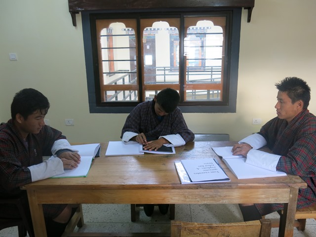 photo:  visually impaired adults learning Braille.